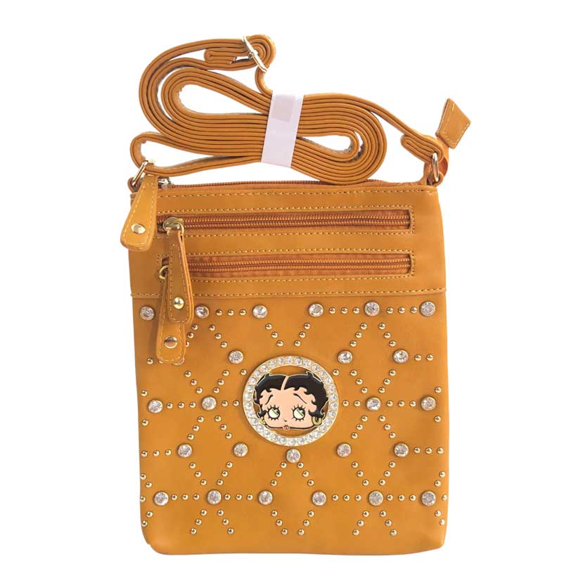 Mensajera Betty Boop de color mostaza, placa circular con imagen de Betty Boop en el centro, piedras decorativas de color dorado y piedras en cristal cortado y pulidas decorativas, dos primeros cierres de color mostaza oscuro y detalles dorados en la parte de enfrente, y un cierre principal en color mostaza oscuro y detalles dorados en la parte superior, asa ajustable del material cuero ecológico, el mismo del resto de la mensajera.